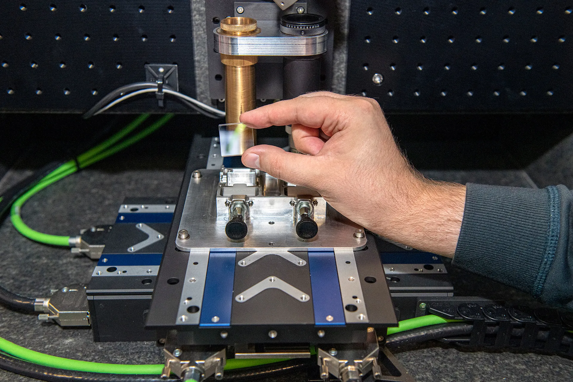 Optical table with femtosecond laser — the equipment used to write data into glass plates